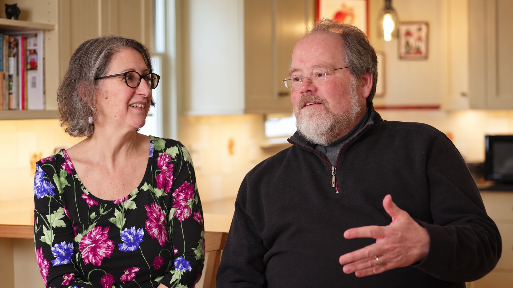 Eva and Todd seated in their kitchen